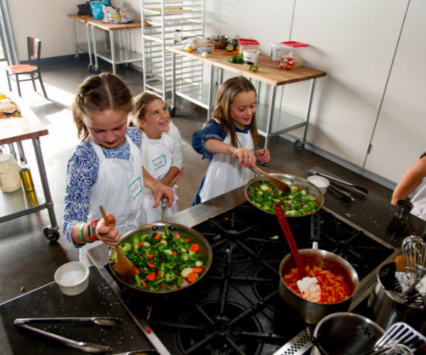 Kids enjoy a cooking class at Uncorked Kitchen.
